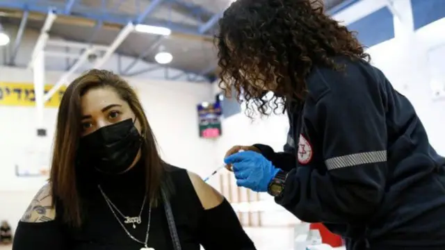 Woman being vaccinated in Israel