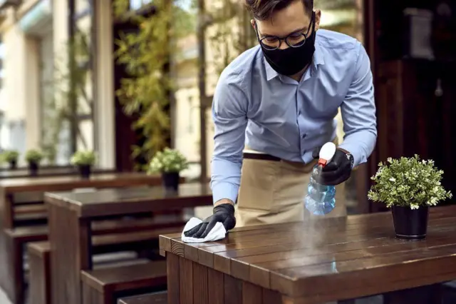 Waiter wearing a mask