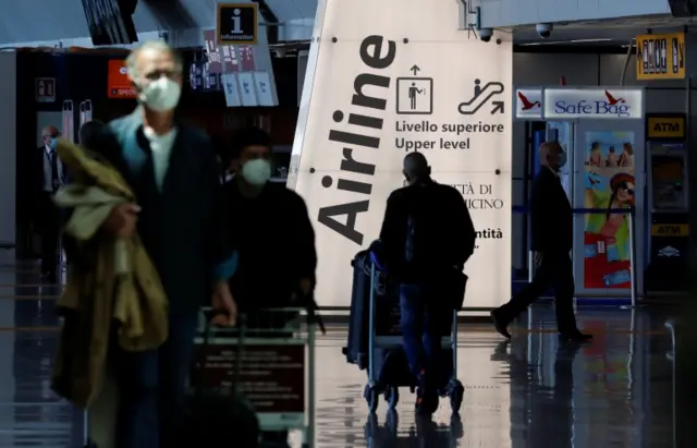 File picture of travellers with their luggage at Fiumicino Airport, Rome