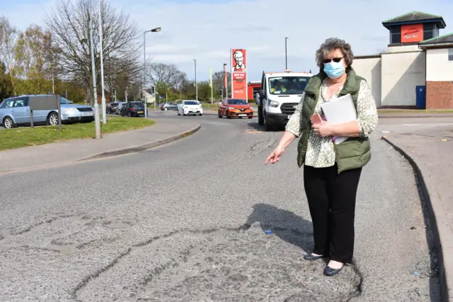 Christine Stewardson at the road off Fatty Island, which has more than 30 potholes