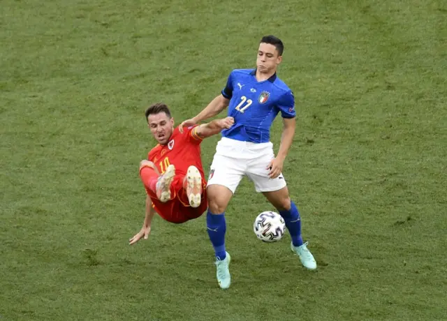 Aaron Ramsey battles for the ball with Italy's Giacomo Raspadori