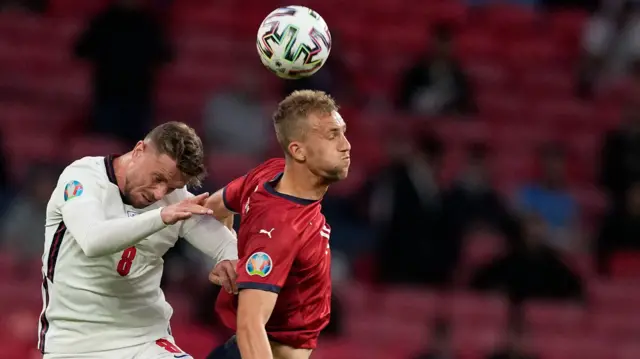 Jordan Henderson (left) competes for a header