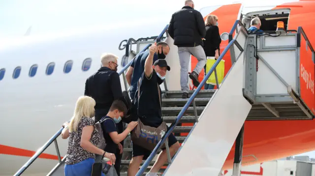 Passengers prepare to board an easyJet flight to Faro, Portugal, at Gatwick Airport in West Sussex after the ban on international leisure travel for people in England was lifted following the further easing of lockdown restrictions.