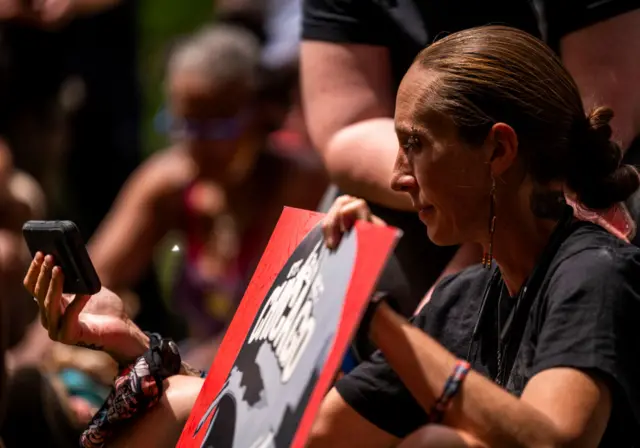 Protesters watched on their phones as the judge read the sentence