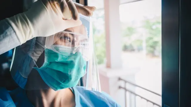 A woman in medical PPE