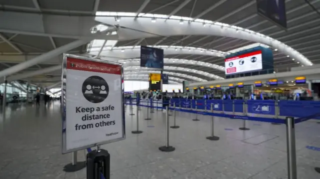 An empty Heathrow with signs up about social distancing