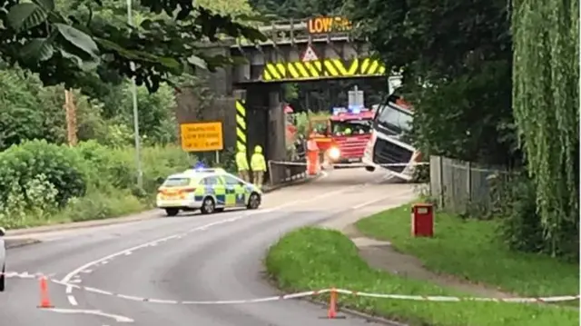 Lorry stuck under bridge