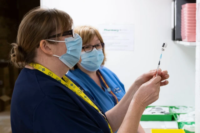 Nurses preparing vaccines