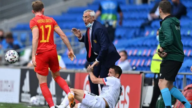 Edoardo Reja, Head Coach of Albania is knocked over on the sidelines by Rey Manaj