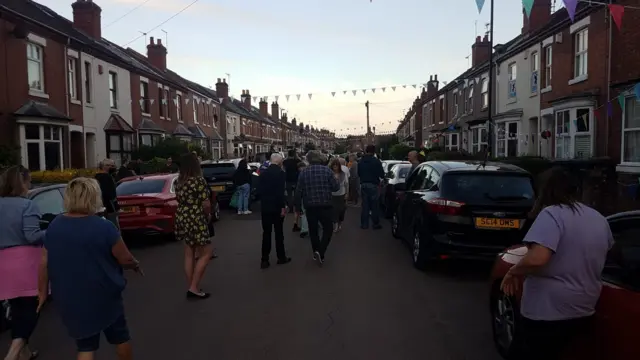 Residents in Stanley Road listening together