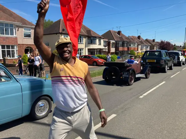 Resident celebrates as cavalcade drives through Coventry