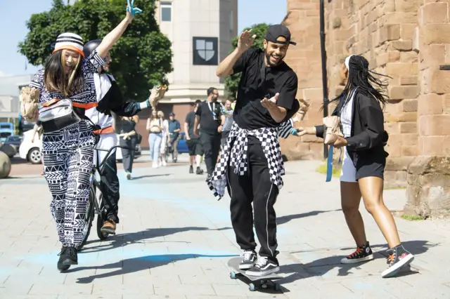 A group of Coventry"s young River Runner performers make their way through the Coventry streets as they trace the path of the river that runs beneath the city during Coventry Moves