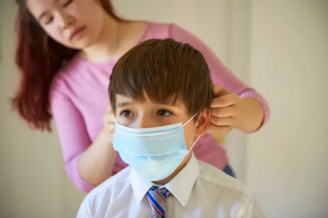 young boy in mask