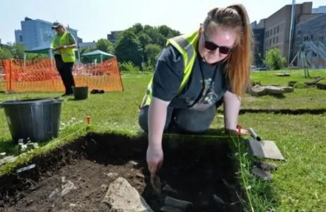 Archaeology student Erika DáNel uncovering part of the Victorian street.