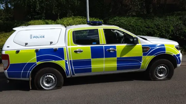 Police van with flat tyres