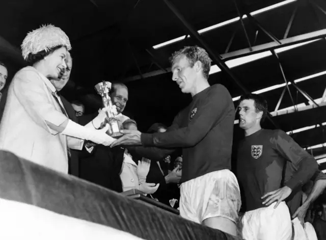 Queen Elizabeth presents the World Cup to Bobby Moore