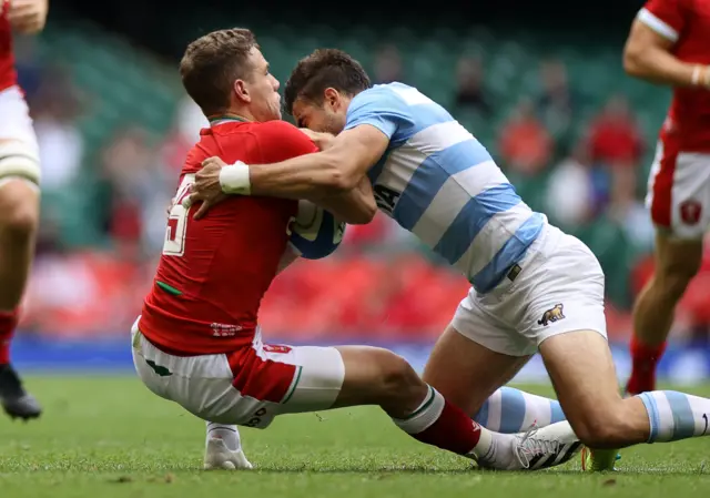 Wales scrum-half Kieran Hardy is tackled high by Argentina full-back Juan Cruz Mallia.