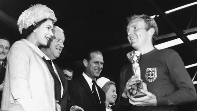 The Queen presents Bobby Moore with the Jules Rimet trophy