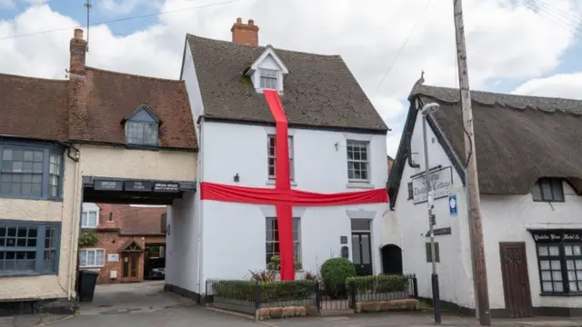 A house in Warwickshire dressed in red ribbon for the Euro 2020 final in a St George's cross.