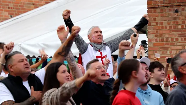 England fans sing the national anthem at The White Horse in Ruddington, Nottinghamshire.