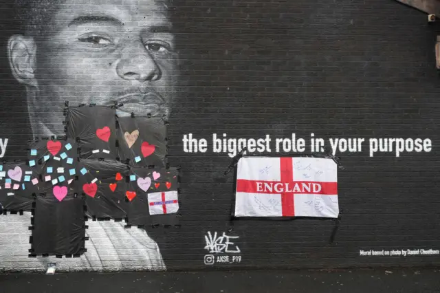 Marcus Rashford mural with positive messages on the covered up graffiti