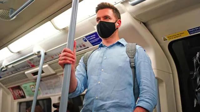 Man wears mask on tube