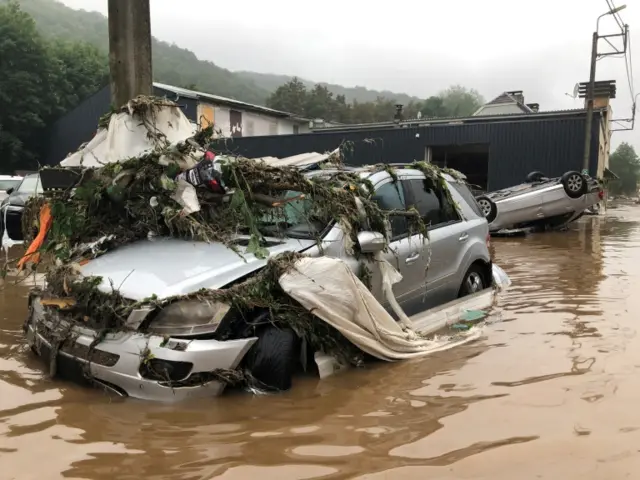 Damaged cars and debris on a flooded street in Pepinster, Belgium. Photo: 15 July 2021