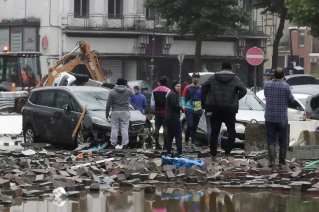 Residents inspect the destruction after heavy rains casued flooding in Verviers, Belgium,