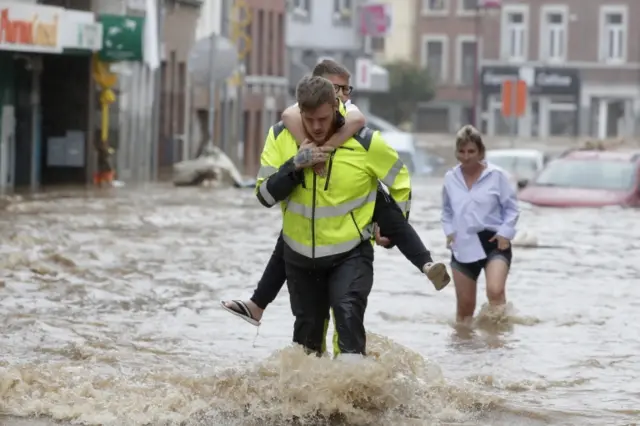 People waded through the flooded streets in Verviers, Belgium