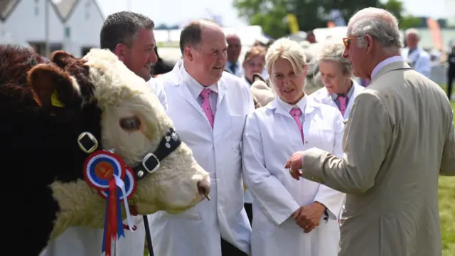 Charles talks to three farmers