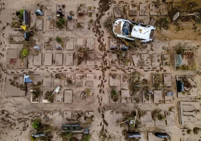 An aerial view taken with a drone shows a damaged car at a cemetery in Bad Neuenahr-Ahrweiler, Germany