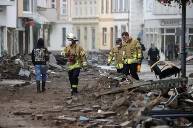 Members of the fire department inspect a damaged area after flooding in Bad Neuenahr-Ahrweiler, Germany,