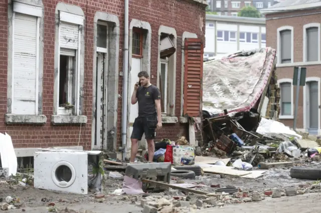 Residents clean up after heavy rains had caused severe flooding in Verviers