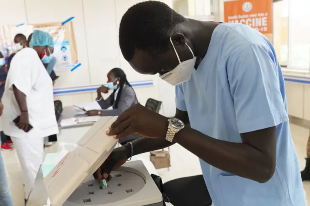 A healthcare worker prepares a dose of a Covid vaccine in Juba, South Sudan