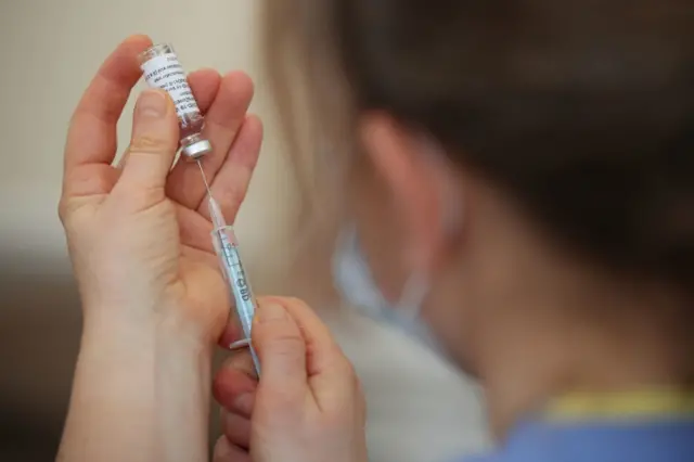 A nurse with a vaccine