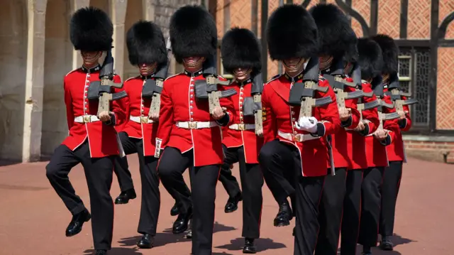 Members of the 1st Battalion Grenadier Guards take part in the Changing of the Guard at Windsor Castle in Berkshire, which is taking place for the first time since the start of the coronavirus pandemic.