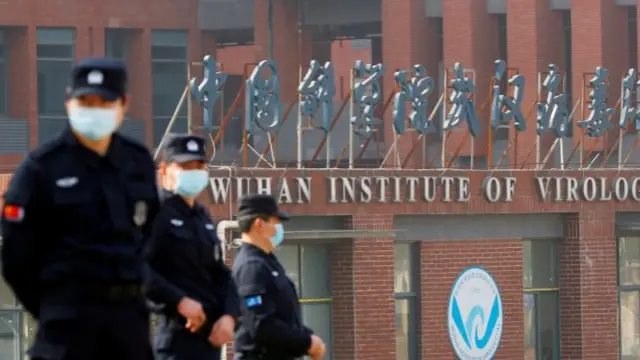 Security personnel keep watch outside the Wuhan Institute of Virology