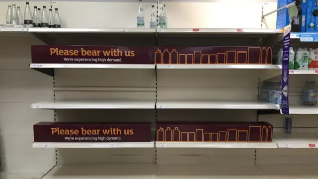 Empty shelves and signs on the soft drinks aisle of a Sainsbury's store in Blackheath, Rowley Regis in the West Midlands.