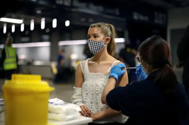 Women receives Pfizer vaccine in London