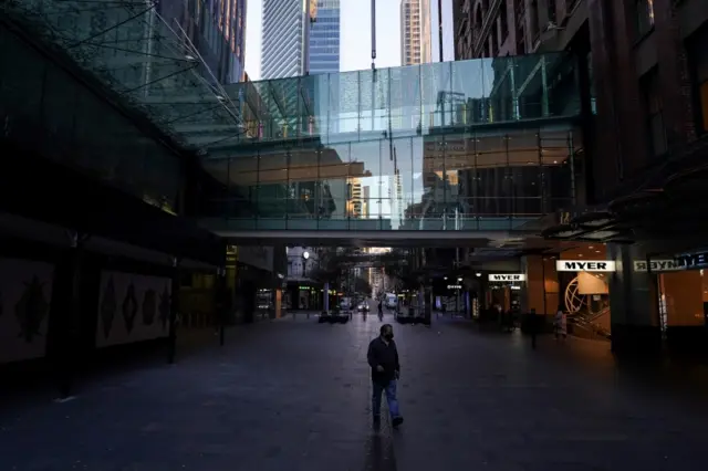 A man seen in empty shopping street in Sydney