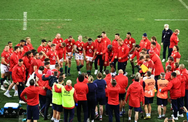 The Lions celebrate in a huddle