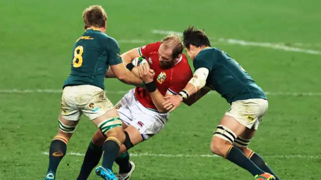 Alun Wyn Jones is tackled by two South Africa players