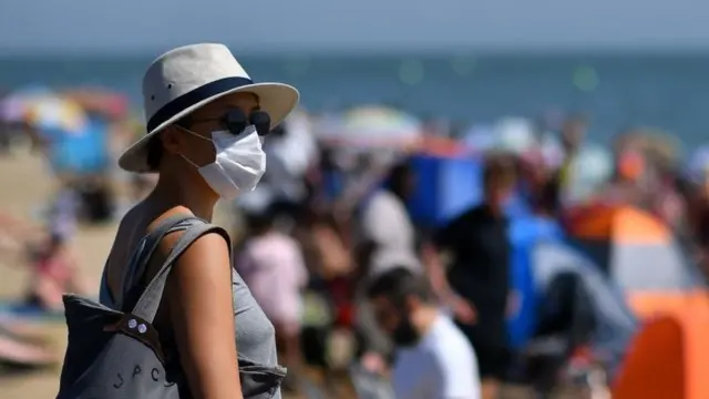 woman in mask among crowd