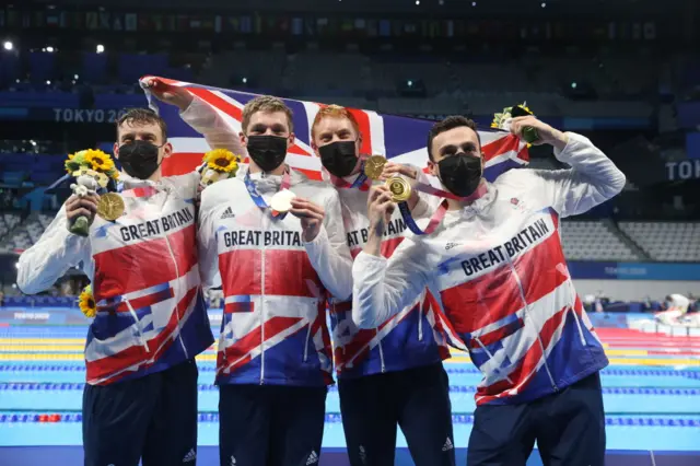 Matthew Richards, Duncan Scott, Tom Dean and James Guy of Great Britain are seen after winning the Men's 4x200m Freestyle Relay on day five of the Tokyo 2020 Olympic Games