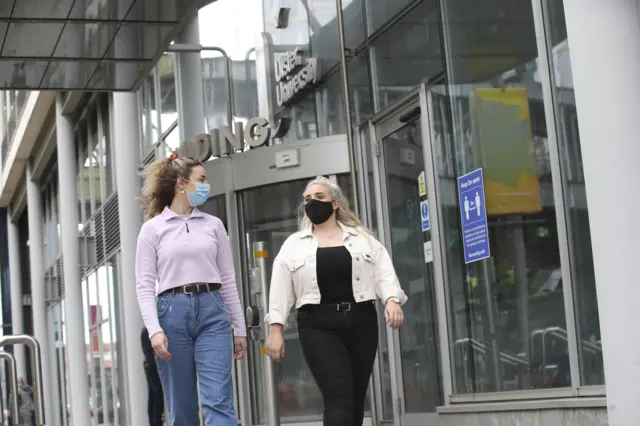 Two students walking outside Ulster University