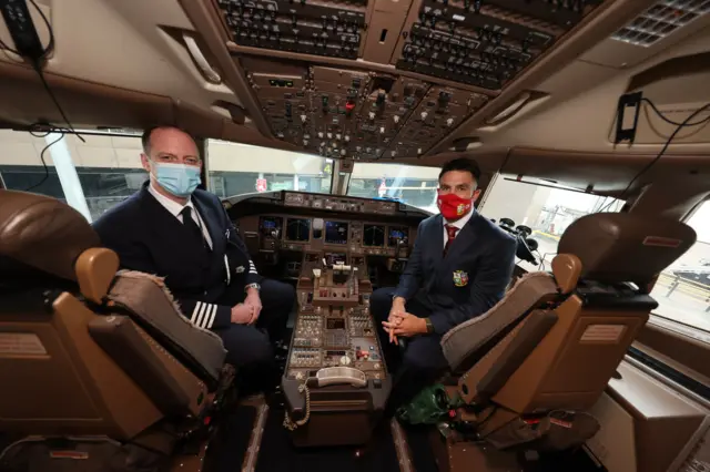 Conor Murray poses for a photo with a plane captain