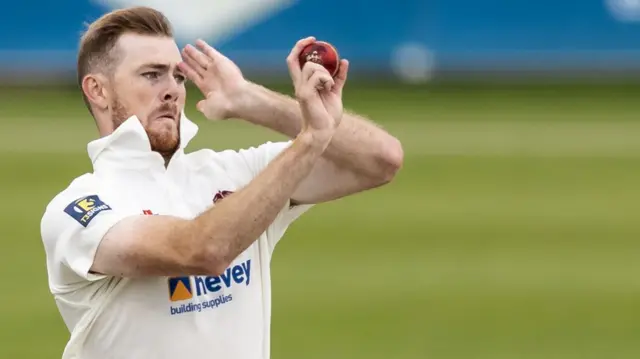 Tom Taylor bowls for Northants