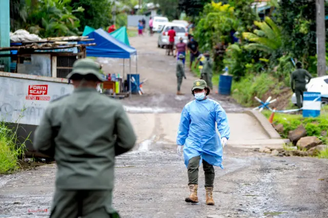 Police patrol a residential area to check people are wearing face masks in Suva on July 3, 2021