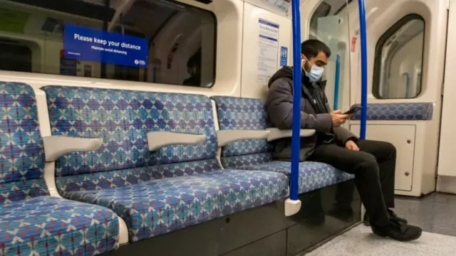 Man wearing a mask on the London Underground