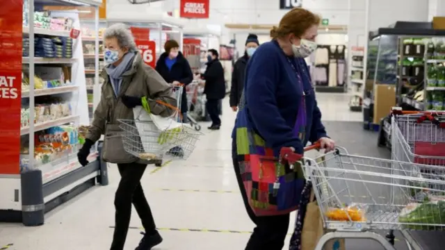 People wearing masks in a supermarket